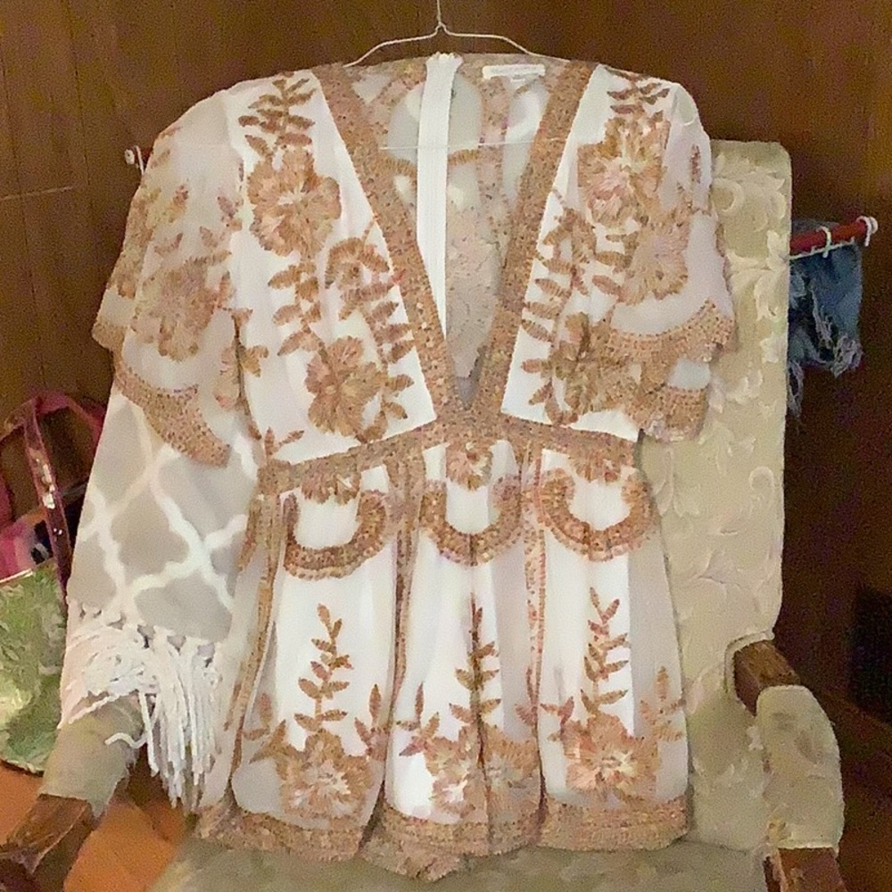 Super cute deep V romper. It’s white with multi colored embroidery